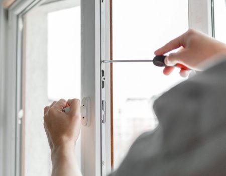 The worker installing and checking window in the house